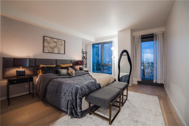 bedroom with baseboards and wood finished floors