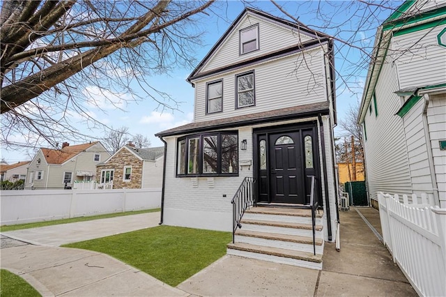 view of front of house with fence and brick siding