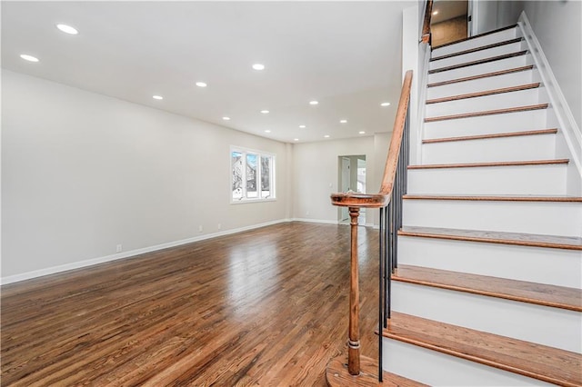 stairway with wood finished floors, recessed lighting, and baseboards