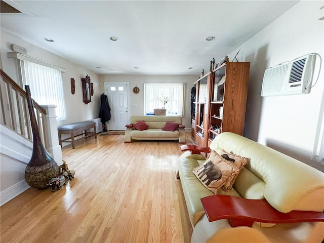 living room featuring recessed lighting, stairs, light wood-type flooring, and baseboards