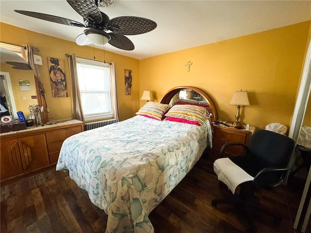 bedroom featuring ceiling fan, wood finished floors, and radiator heating unit