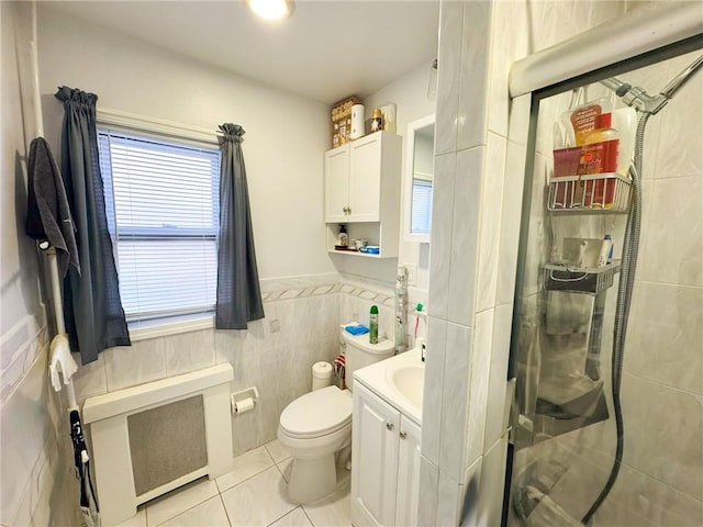 bathroom with vanity, tile walls, toilet, and plenty of natural light