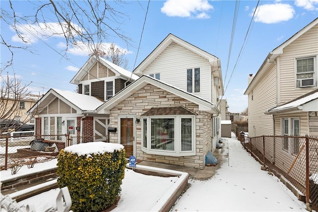 view of front of house featuring cooling unit, a fenced backyard, and stone siding