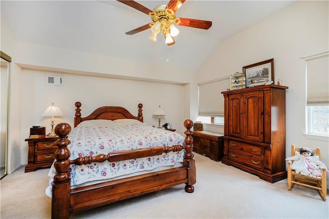 bedroom with light carpet, visible vents, ceiling fan, and lofted ceiling