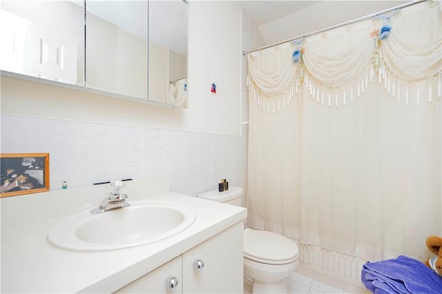 bathroom with vanity, tile walls, curtained shower, and toilet