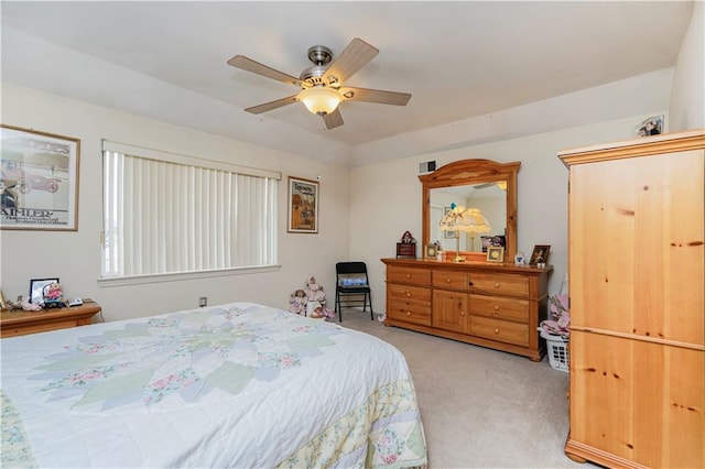 bedroom featuring light carpet and a ceiling fan