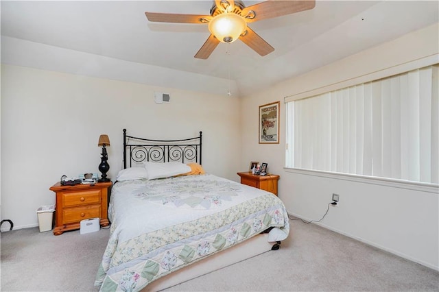 carpeted bedroom with a ceiling fan and baseboards