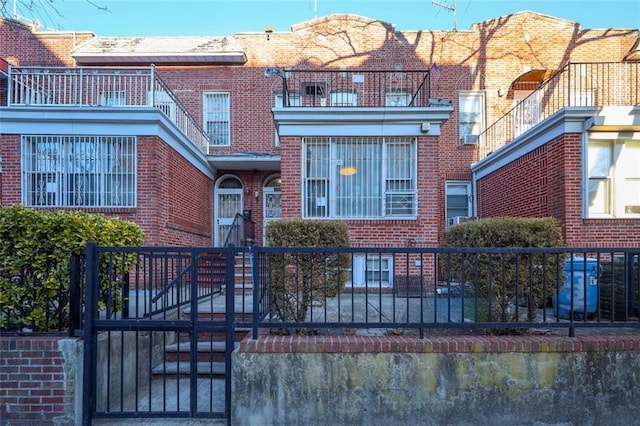 view of property with brick siding and a fenced front yard