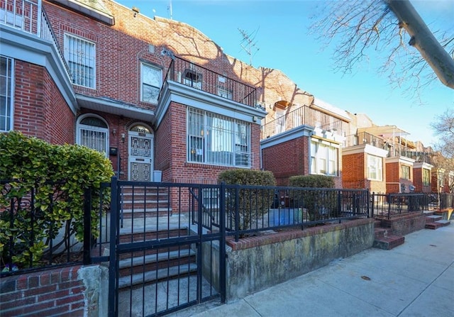 view of front of house with brick siding and a fenced front yard