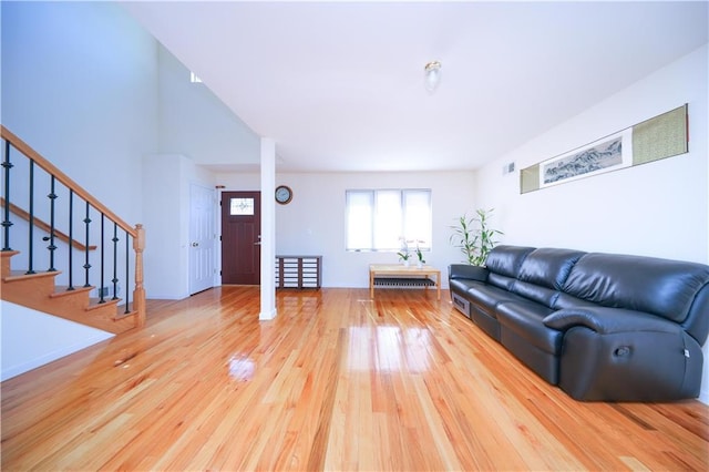 living room featuring wood finished floors and stairs