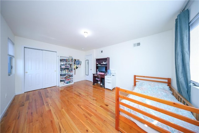 unfurnished bedroom featuring visible vents, baseboards, and light wood-style floors