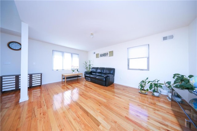 unfurnished room with visible vents and wood finished floors