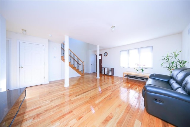 living area featuring stairway and light wood-style floors