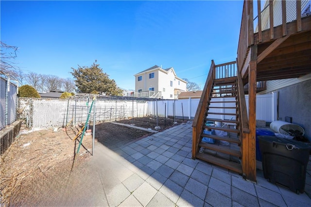 view of patio / terrace featuring stairs and a fenced backyard