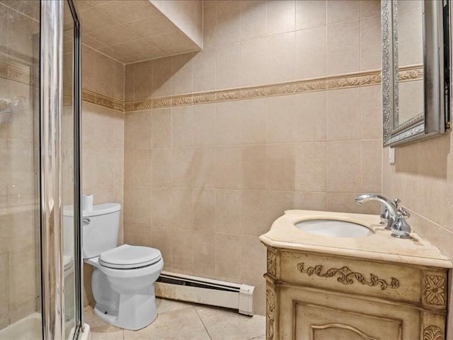 bathroom with tile patterned floors, toilet, a baseboard heating unit, tile walls, and a shower stall