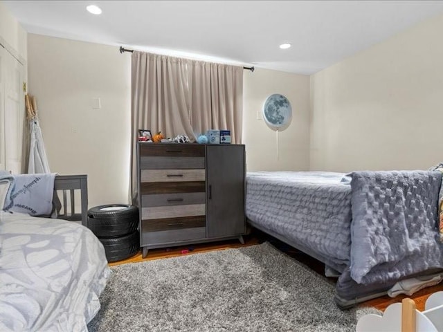 bedroom featuring recessed lighting and wood finished floors