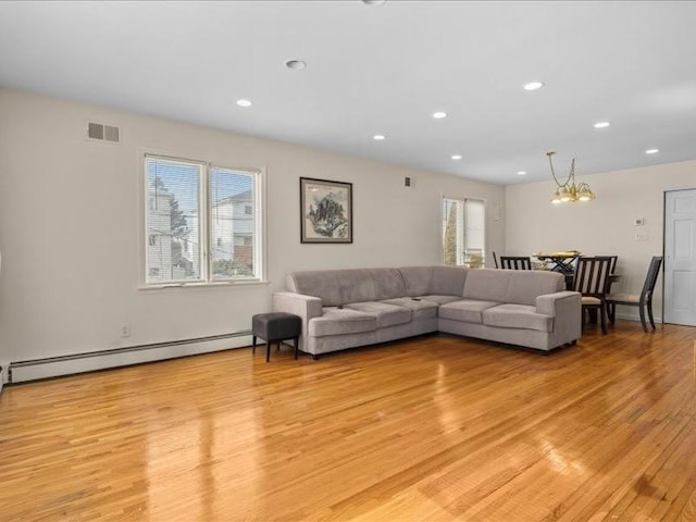 living room with visible vents, recessed lighting, an inviting chandelier, light wood finished floors, and a baseboard radiator