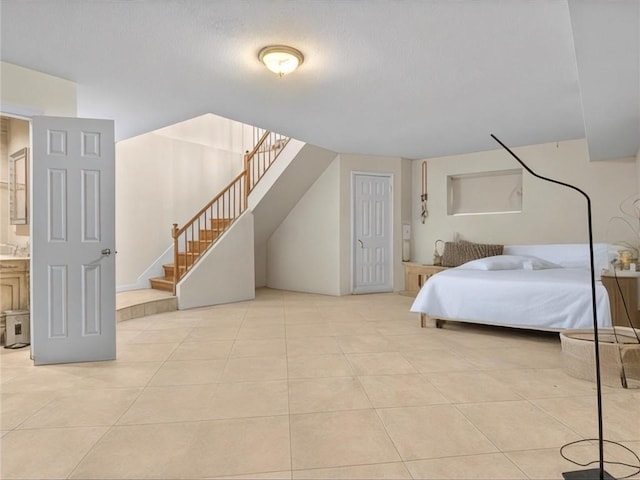 bedroom featuring tile patterned floors and a textured ceiling