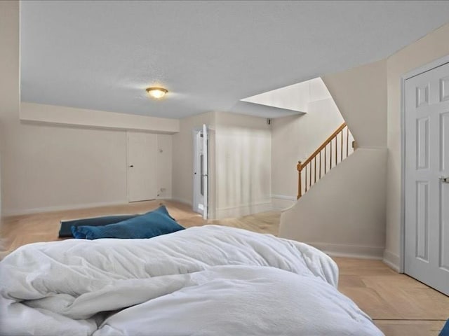 bedroom featuring baseboards and a textured ceiling