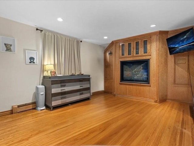 living room with recessed lighting, a baseboard radiator, baseboards, and wood finished floors