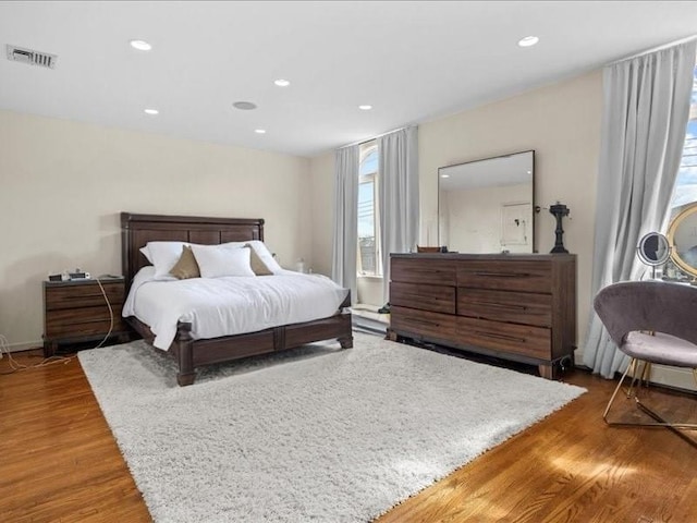 bedroom with visible vents, recessed lighting, and wood finished floors