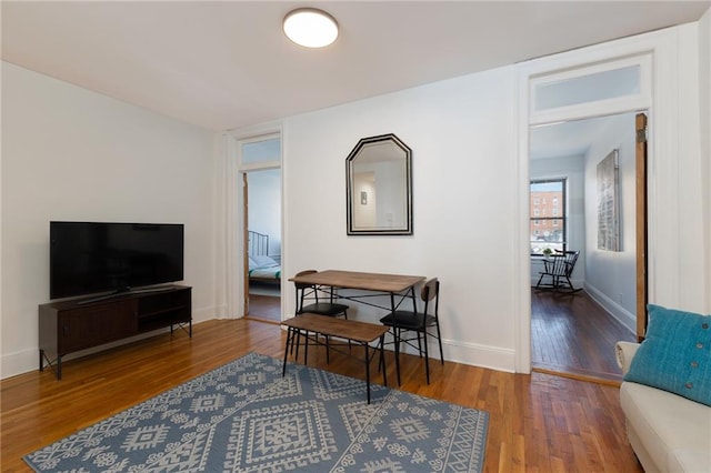 living area featuring wood finished floors and baseboards