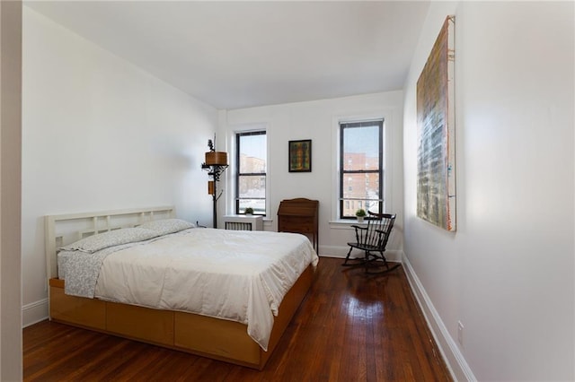 bedroom with baseboards and wood-type flooring