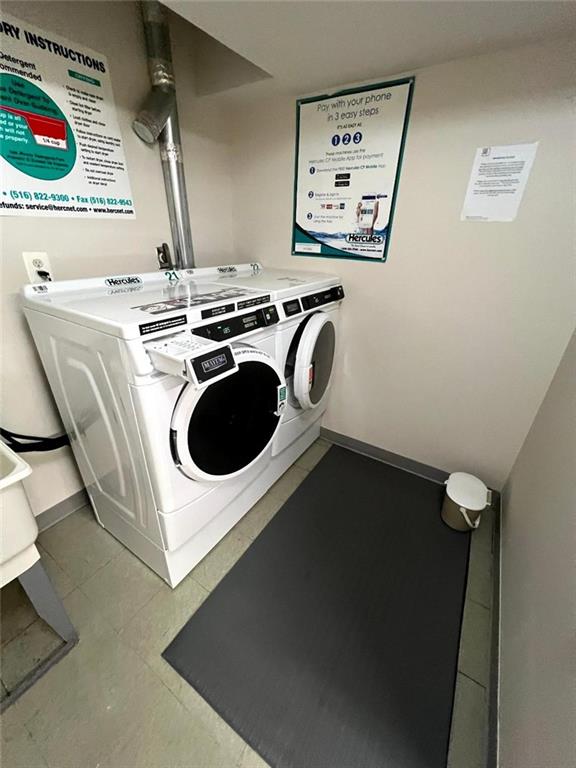 common laundry area featuring baseboards, separate washer and dryer, and tile patterned flooring