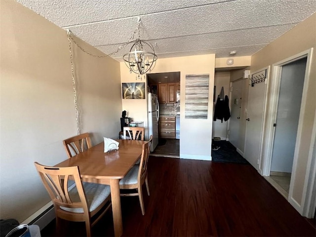 dining room featuring a baseboard radiator, baseboards, dark wood-style flooring, and a chandelier