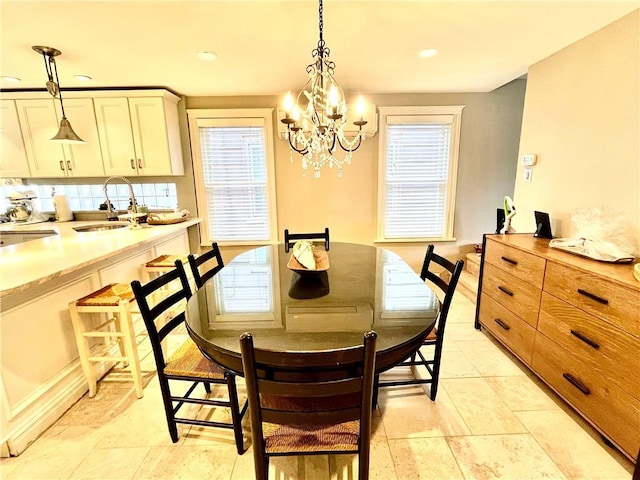 dining area with recessed lighting and a notable chandelier