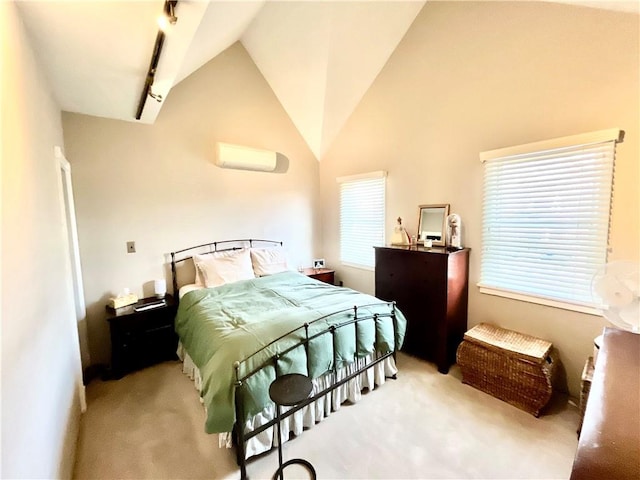 carpeted bedroom featuring track lighting, an AC wall unit, and vaulted ceiling