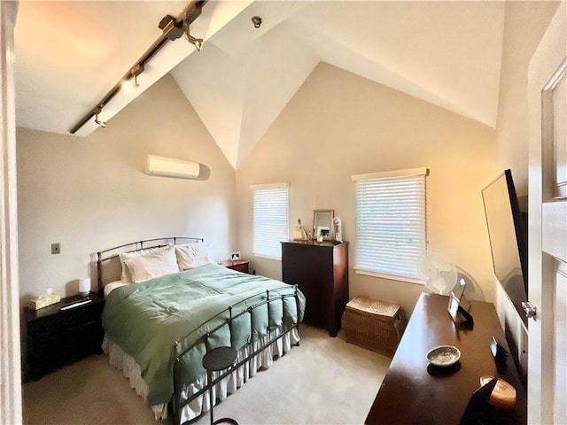 carpeted bedroom with a wall mounted air conditioner, high vaulted ceiling, and track lighting