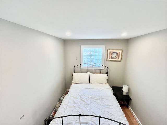 bedroom with baseboards, recessed lighting, and wood finished floors