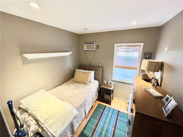 bedroom with recessed lighting, baseboards, dark wood-style floors, and a wall mounted air conditioner