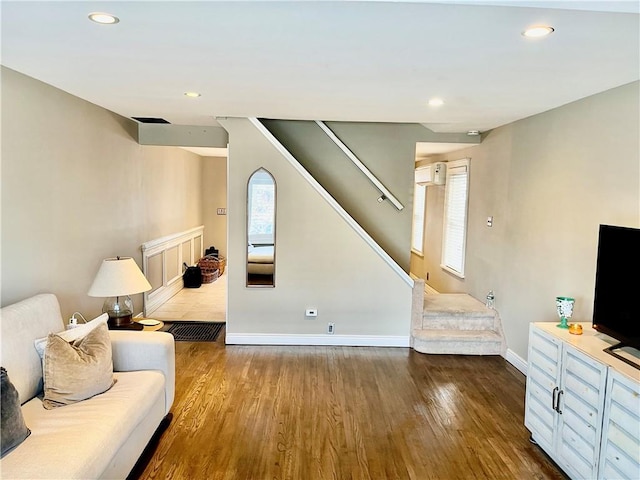 living room with baseboards, recessed lighting, stairs, and wood finished floors
