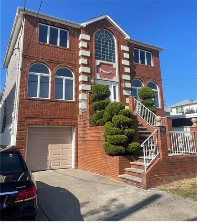 view of front of home with brick siding, concrete driveway, stairs, and a garage