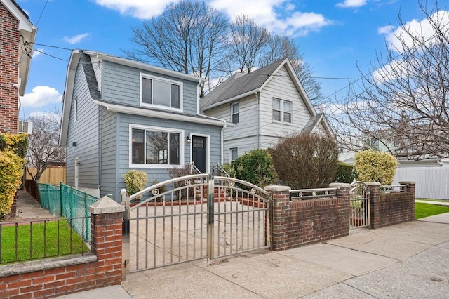 view of front of house with a fenced front yard and a gate