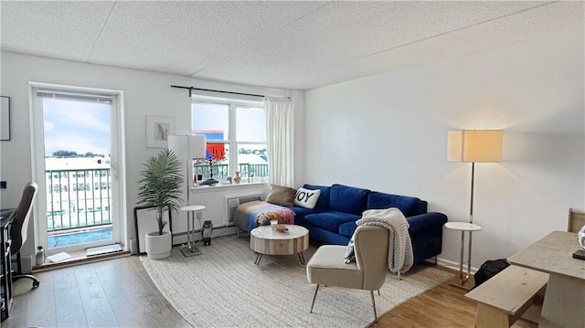 living area featuring wood finished floors and a textured ceiling