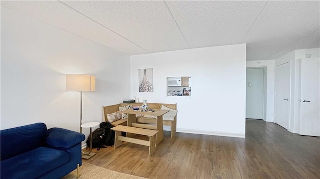 living area with a textured ceiling and wood finished floors