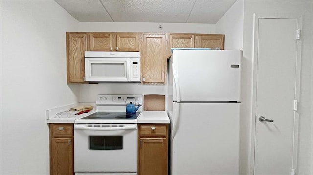 kitchen with white appliances, brown cabinetry, and light countertops