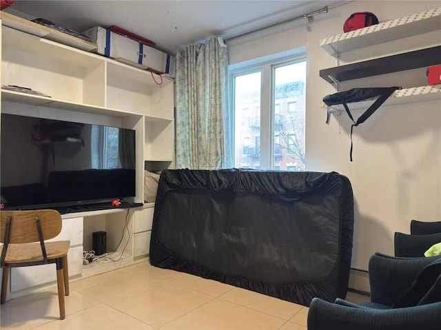 tiled living area featuring a baseboard radiator