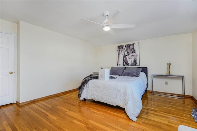 bedroom with baseboards, light wood-type flooring, and ceiling fan