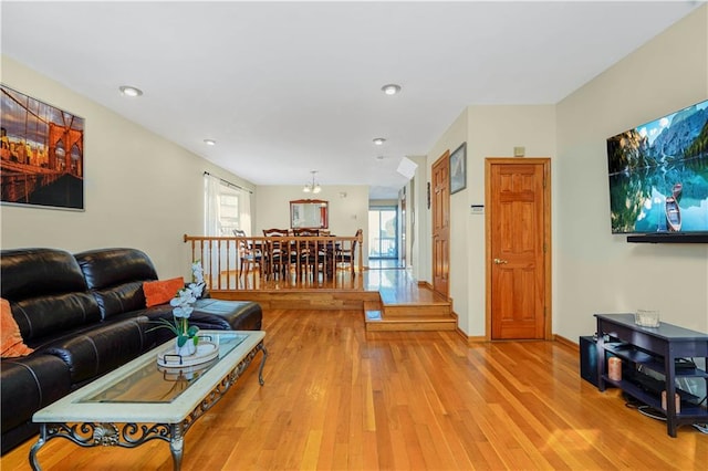 living room with recessed lighting, light wood-type flooring, and baseboards