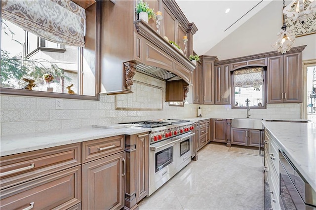 kitchen featuring range with two ovens, light stone countertops, vaulted ceiling, and a sink