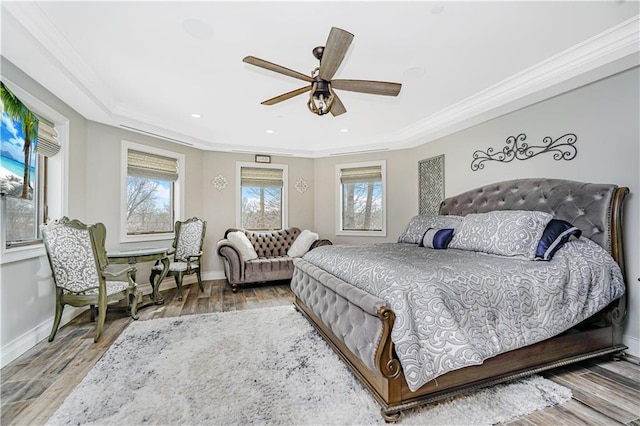 bedroom with ceiling fan, baseboards, wood finished floors, and ornamental molding