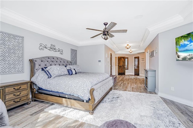 bedroom featuring ceiling fan, baseboards, wood finished floors, and ornamental molding