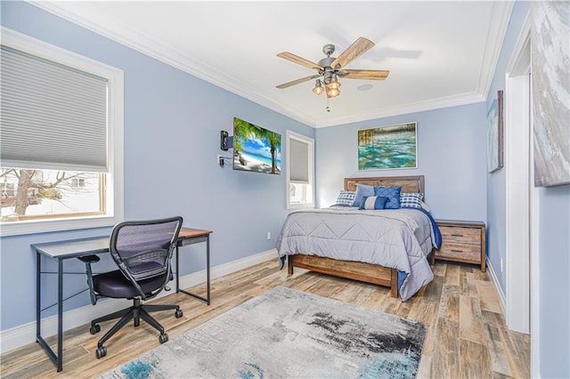 bedroom featuring multiple windows, crown molding, baseboards, and wood finished floors