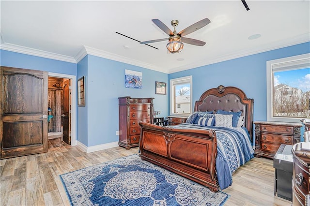 bedroom with light wood-style floors, baseboards, and ornamental molding