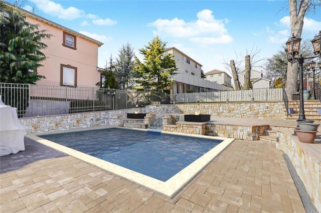 view of swimming pool featuring a patio and a fenced backyard