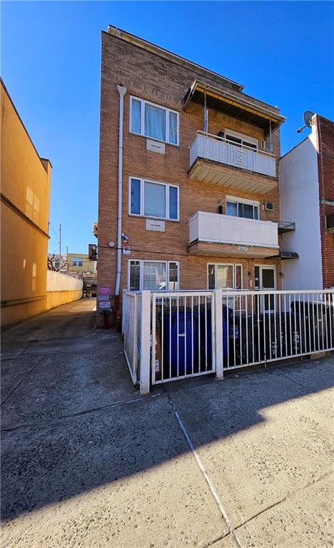 1820 73rd St Unit 1A, Brooklyn, NY 11214 - rear view of house featuring brick siding